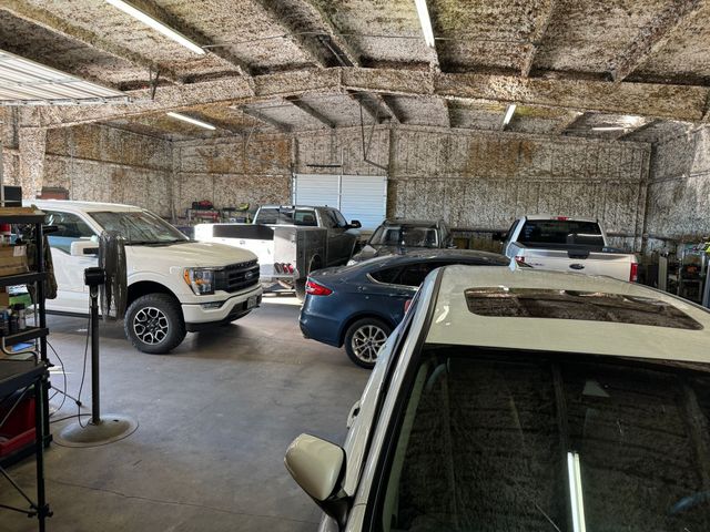 A lot of cars are parked in a garage.