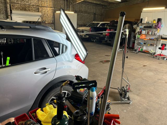 A car is being worked on in a garage.