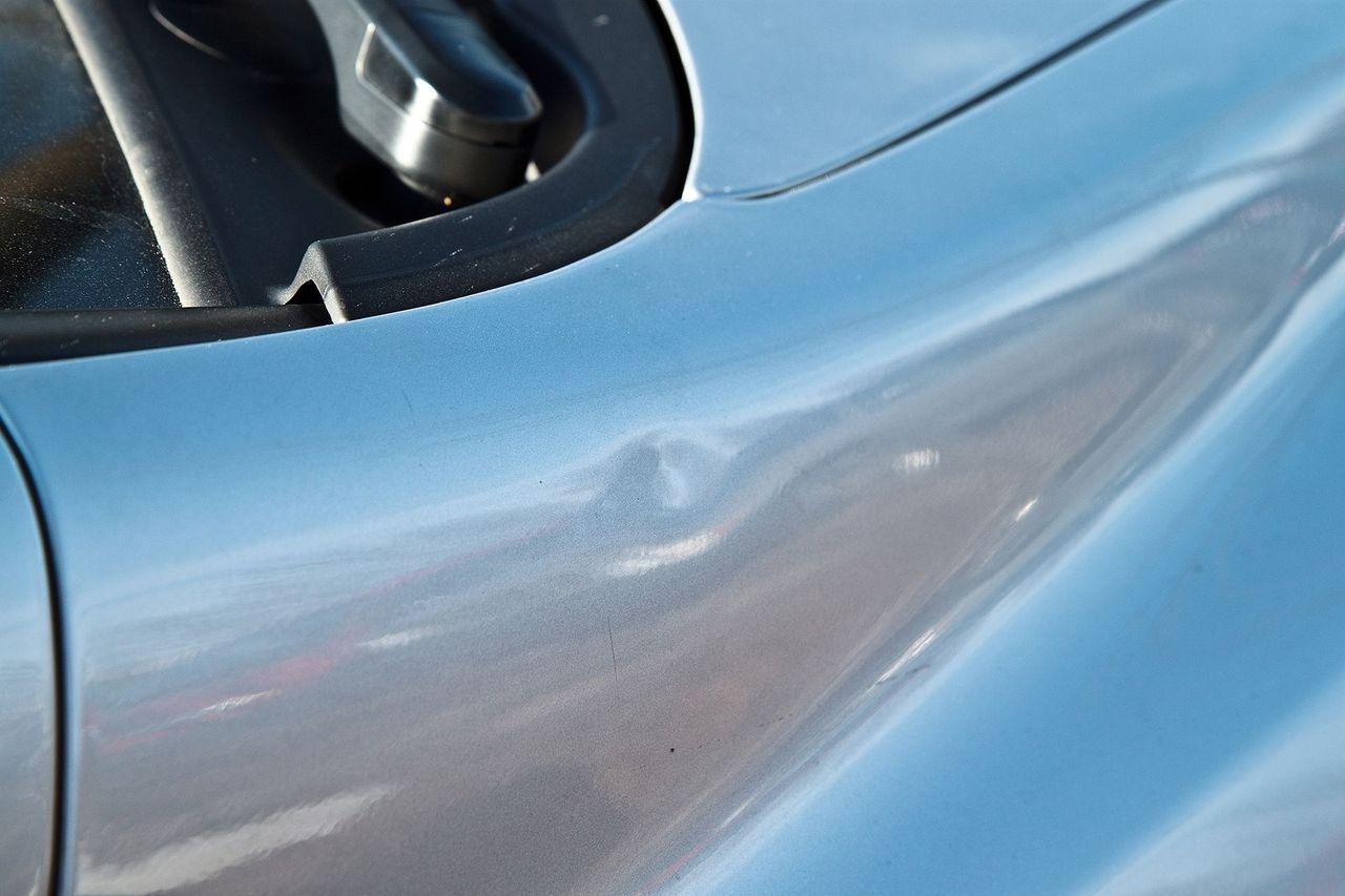Paintless dent repair being performed on a vehicle